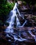 Water cascades over High Shoals Falls in Hiawassee, Georgia.