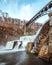 Water cascading down New Croton dam with a bridge arching over the waterfall