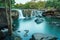 Water cascading from small cliff of Tad Tone waterfall with misty water effect