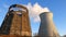 Water cooling tower stack smoke over blue sky