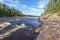 The water course of Ounasjoki â€“ Molkojoki river bordered by pin forests in Finnish Lapland