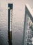 Water depth measuring pole in a river to gauge high or low level of water, Vertical image. Nature environment monitor concept