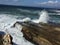 Water draining from rock and wave crashing over it in Montana De Oro California