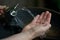 Water from drinking fountain flows into woman`s hand