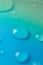 Water drop background.water drops on a blue background with a colored green gradient.Fluid texture in cold tones