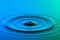 Water drop close up with concentric ripples colourful blue and g