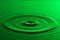 Water drop close up with concentric ripples colourful green surf