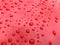 Water drop pattern on red car hood, bonnet