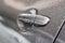 The water droplet from raindrops on silver color car`s body, the dew cover on the gray back door handle of the car, close up phot