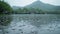 water droplets formed on Mountain lake during a rainy day, high detail to convey the natural beauty of raindrops