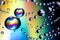 Water droplets on iridescent background with rainbow colors