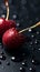 water droplets on red cherries, black background