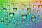 Water drops. Abstract background. Colored macro texture with many drops. Iridescent wet gradient. Heavily textured image. Small