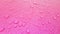 Water Drops background on the pink glossy surface, Rain droplets