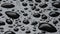 Water drops on a black plastic surface