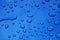 Water drops on blue car body threated with protective coating