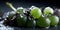 Water Drops on Group of Delicious Fresh Green Grapes As Defocused Background