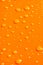 Water drops on orange metal ba