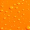 Water drops on orange metal ba