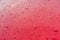 Water drops of raindrop on red metallic surface of modern car