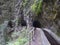 Water duct levada and mysterious tunnel on hiking trail Casa del Monte to Los Tilos. Beautiful nature reserve on La