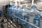 Water factory. Plastic bottle or gallon after washing and cleaning on automated conveyor line