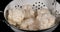 Water falling on Cauliflower, brassica oleracea, against Black Background