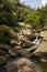 Water falls between rocks in sunny day - Serra da Canastra National Park - Minas Gerais, Brazil