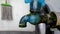 The water faucet made of blue plastic looks dirty, overgrown with moss, it doesn\\\'t work properly