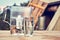 Water filter jug and a transparent glass cup of clean water in front of wooden draw well outdoors in summer evening