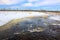 Water flowing along farmland during the spring melt