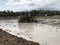 Water flowing into the channel which is pumped by submersible pump into agricultural natural rice field in farm