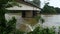 Water flowing down on the river Kalu Ganga through the base of the large bridge view from the bank