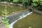 Water flowing over a manufactured waterfall