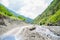 Water flowing over river rocks near mountains in Nathia Gali, Abbottabad, Pakistan