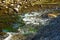 Water flowing over rocks and stones