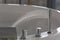 Water flows from a luxurious modern water faucet into a large modern bathtub. Spa, relaxation, hygiene concept.