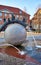 Water fountain in the form of a ball with a tree trunk and sculptures sitting on it. Wernigerode old town