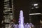 Water fountain jets with the skyscrapers of the Milan Citylife district in the background at night, Italy