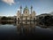 Water fountain mirror reflection panorama of historic catholic baroque church of St Charles Karlskirche, Vienna Austria