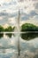 Water fountain reflected in the lake of a city park