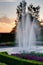 Water fountain with sunset at a park