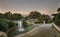 Water fountains at city park Jardins del Mirador in Barcelona during sunset