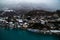 Water Front Wooden Chalets in Interlaken Switzerland on the Aare River with Misty Clouds and Vibrant Blue Water.