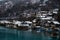 Water Front Wooden Chalets in Interlaken Switzerland on the Aare River with Misty Clouds and Vibrant Blue Water.