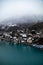 Water Front Wooden Chalets in Interlaken Switzerland on the Aare River with Misty Clouds and Vibrant Blue Water.