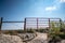 Water gap under a livestock fence where animals can go under a washed out section