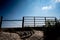 Water gap under a livestock fence where animals can go under a washed out section