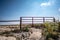 Water gap under a livestock fence where animals can go under a washed out section