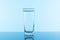 Water glass on blue background. Glass with clean drinking water
